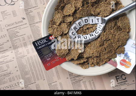 A SPOONFUL OF 'CREDIT CRUNCH' BREAKFAST CEREAL WITH COPY OF FINANCIAL PAPER AND CREDIT CARDS REPRESENTING FINANCIAL CRISIS,UK... Stock Photo