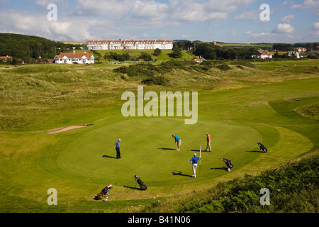 Golfers on the 3rd green Ailsa Course championship course Turnberry Ayrshire Scotland with the Turnberry Hotel in the distance Stock Photo