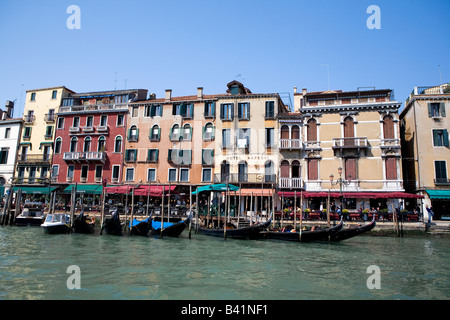 Hotel Marconi on the banks of the Grand canal with moored Gondolas in front Venice Italy Stock Photo