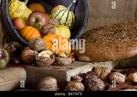 Table and wooden board with bread and autumn products for thanksgiving Stock Photo