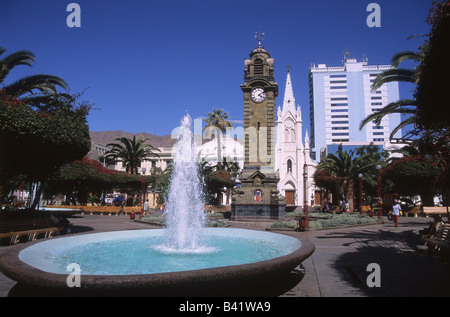 Fountain and clock tower in Plaza Colon, St. Joseph's / San José cathedral behind, Antofagasta, Chile Stock Photo