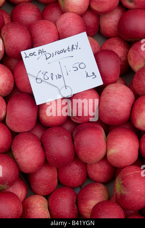 fresh local red Discovery apples on sale on market stall in Ludlow England UK Stock Photo