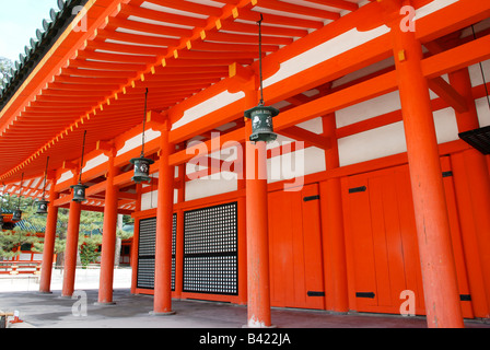 Red painted temple wall and metal lanterns at the Hainan Shrine, Kyoto. Stock Photo