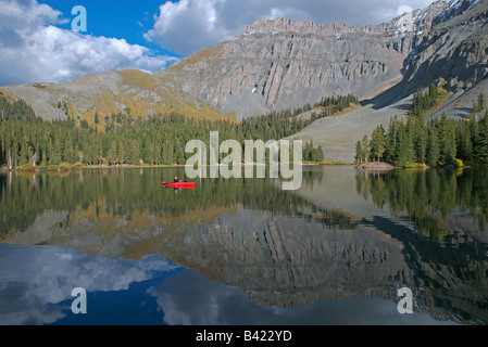 A sea kayaker fly fishing in an alpine lake high up in the san juan mountains near telluride, colorado at sunset in the fall Stock Photo