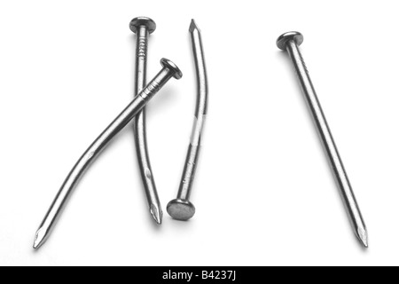 Four (4) common nails, 3 bent and 1 straight, black and white, isolated against white specular highlights Stock Photo