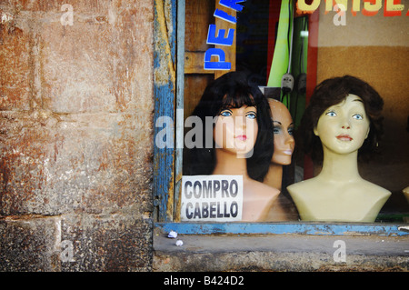 'We Buy Hair' reads a sign in the window of a barber shop in Cuzco, Peru. Stock Photo