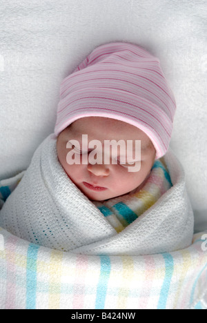 A newborn baby swaddled in blankets Stock Photo