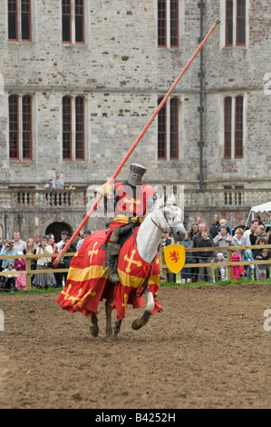 A galloping knight on horseback entertains the crowd during a jousting re-enactment at Lulworth Castle in Dorset England UK Stock Photo