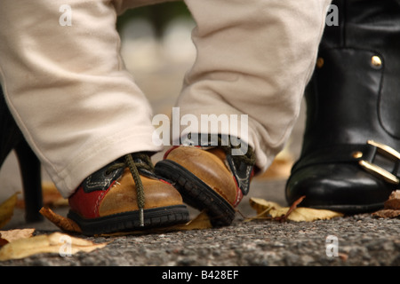Baby's and mother's boots. Stock Photo