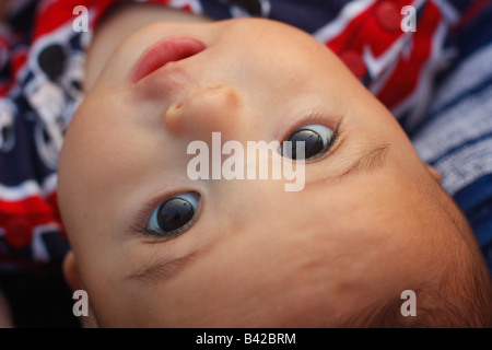 Six month old baby boy looking up from stroller. Baby is half Asian and half Caucasian. Stock Photo