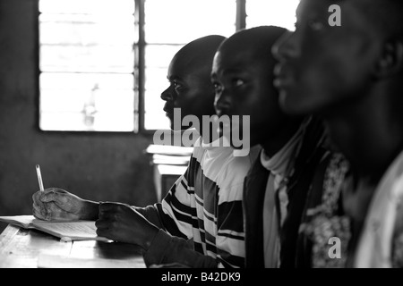 Rwandan secondary students listen attentively in their boarding school classroom. Stock Photo