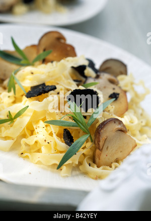 Pasta with ceps and black truffles Stock Photo