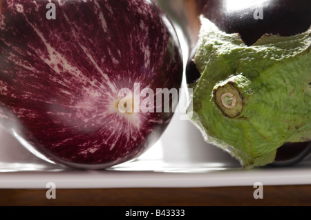 aubergines on white plate Stock Photo
