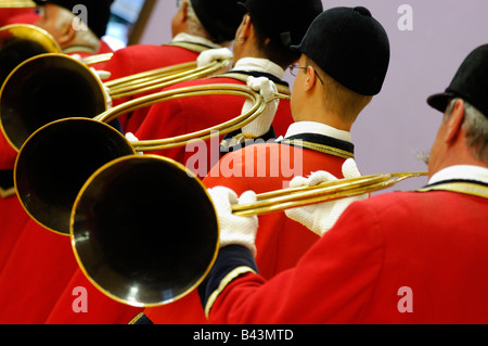 Group of french musicians playing on hunting horn and with traditional red dress - France Stock Photo