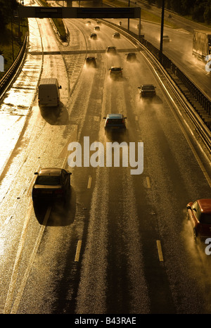 motorway traffic during evening rain storm Stock Photo