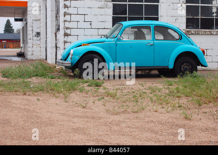 Old Volkswagen Beetle beside a service station Stock Photo