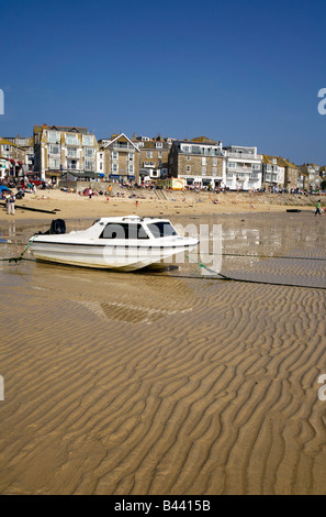 A white boat on St. Ives harbour beach at low tide. Stock Photo