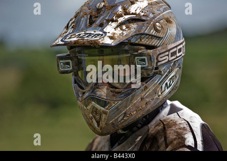 Man with crash helmet involved in motocross racing, racing circuit, Darvel, Ayrshire, Scotland, UK Stock Photo