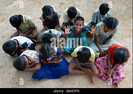 One indian girl waving in group of children in a village in India Stock Photo