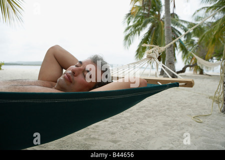South American man sleeping in hammock Stock Photo