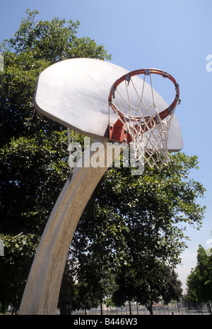 basketball backboard, rim, and net on support pole in city park. Stock Photo