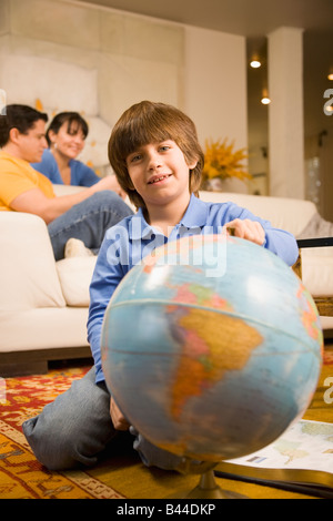Hispanic boy holding globe Stock Photo