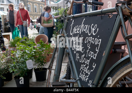 The Treehouse Organic food vegetarian cafe sign on old bike at Aberystwyth farmers market and food fair Wales UK Stock Photo