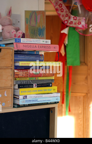 Cookbooks on a shelf in a kitchen Stock Photo