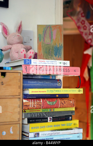 Cookbooks on a shelf in a kitchen Stock Photo