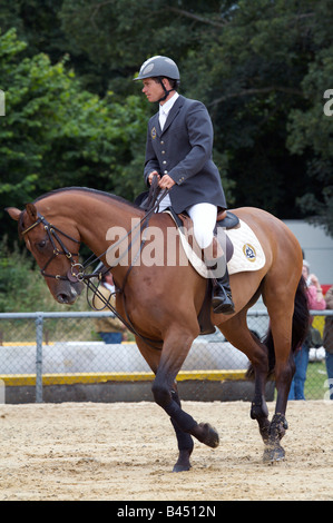 Competitive show jumping horse and rider, practicing in the training ring before the contest. Kent County Show, Detling,  2008. Stock Photo