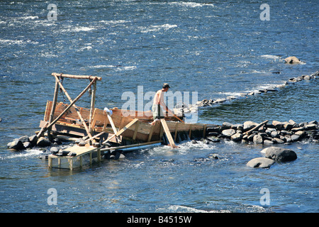 An eel weir on the Delaware River between Pennsylvania An eel man is working on the weir in the middle of the river. Stock Photo