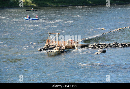 An eel weir on the Delaware River between Pennsylvania An eel man is working on the weir in the middle of the river. Stock Photo