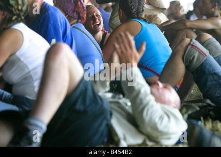 People relaxing in dance tent as the day's music gets underway.Glastonbury Music Festival 2003 Held in Somerset,UK Stock Photo