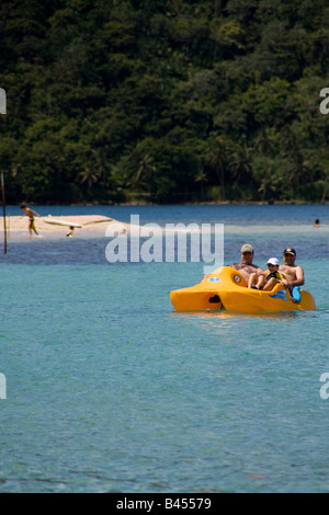Panama, Isla Grande, Tourists enjoy a trip on the calm and crystalline Caribbean waters in a pedal boat Stock Photo