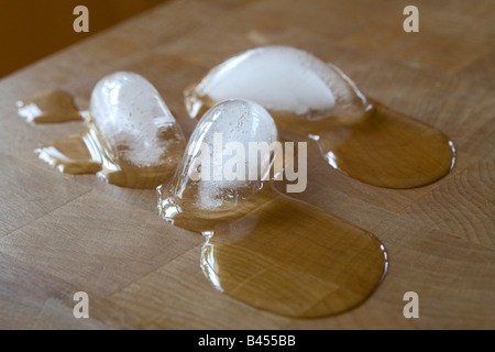 Melting ice cubes on counter top Stock Photo