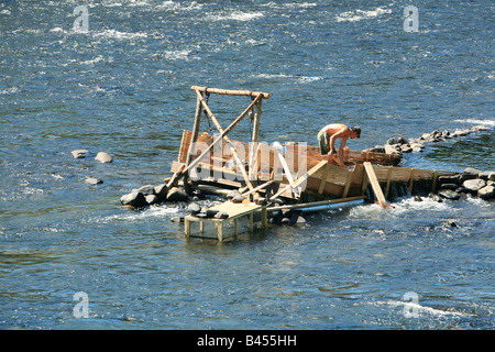 An eel weir on the Delaware River between Pennsylvania An eel man is working on the weir in the middle of the river. Stock Photo