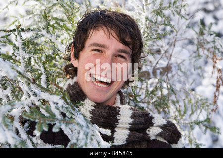 Austria, Salzburger Land, Altenmarkt, Young man carrying fir tree Stock Photo