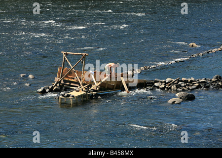 An eel weir on the Delaware River between Pennsylvania An eel man is working on the weir in the middle of the river. Stock Photo