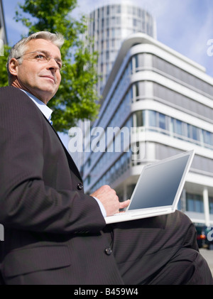 Germany, Baden-Württemberg, Stuttgart, Businessman using laptop Stock Photo