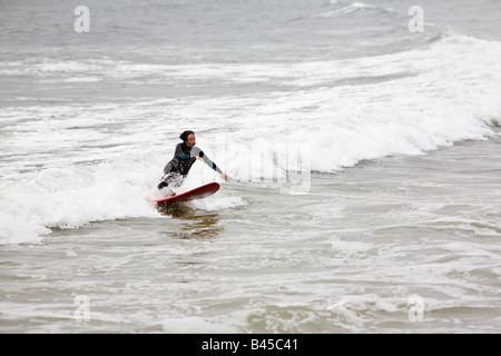 Surfing waves of Far Rockaway Beach during very foggy day New York USA Stock Photo