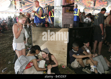 People relax in the Dance tent as the day's music sessions begin.  Glastonbury Music Festival 2003 Held on 1,000 acre Worthy Farm in Somerset, UK, over three days at the end of June almost every year since 1970, the festival now attracts a capacity crowd of 112,500.  This year festival tickets sold out in 18 hours. Stock Photo