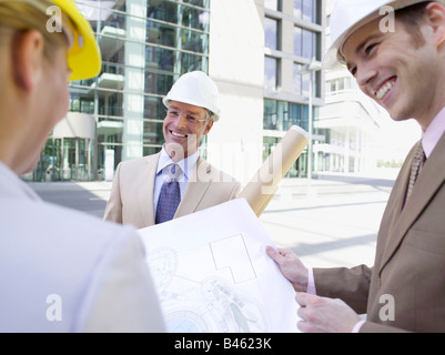 Germany, Baden-Württemberg, Stuttgart, Three architects discussing working plan Stock Photo