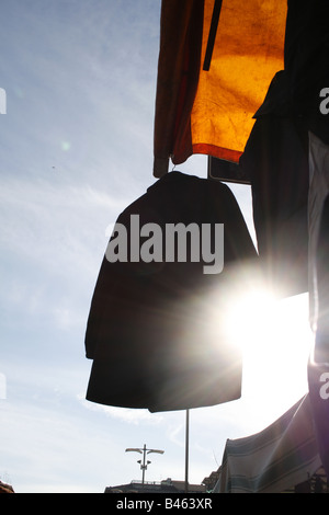 jacket on market clothes stall in morning sun Stock Photo