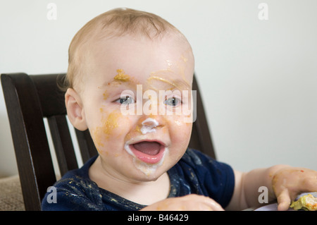 A ten month old baby boy at mealtime. Stock Photo