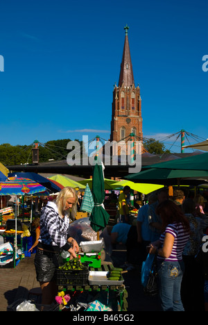 Open air market with St Anna s Church in the background in Liepaja Latvia Europe Stock Photo