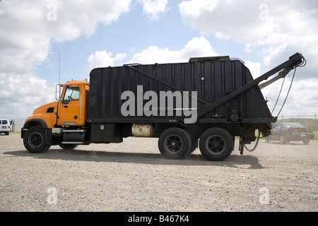 A modern garbage truck over a bright blue sky Stock Photo