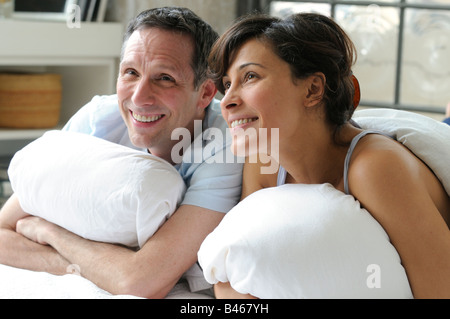 Lying In Bed Watching TV Stock Photo