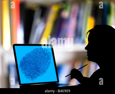 police woman checking fingerprint on laptop computer Stock Photo