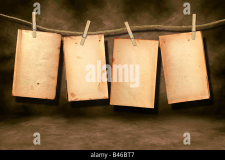 Distressed Stained Old Work Book Open For Your Text or Designs Hanging on a Rope By Clothespins Stock Photo