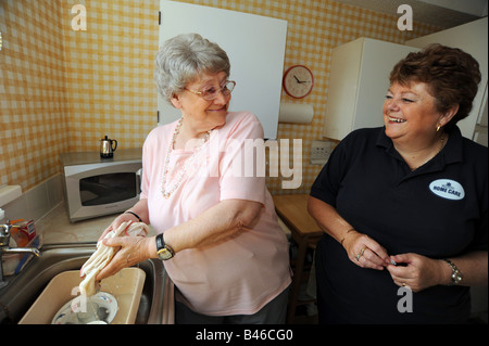 Council Homecare Staff enable elderly and disabled people to live in their own homes through support and help with cleaning Stock Photo